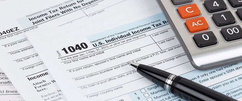 1040 Income Tax Form on Desk with Calculator